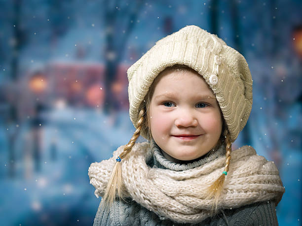 istock Wonderful little girl under falling snow, snowflakes. 624224904