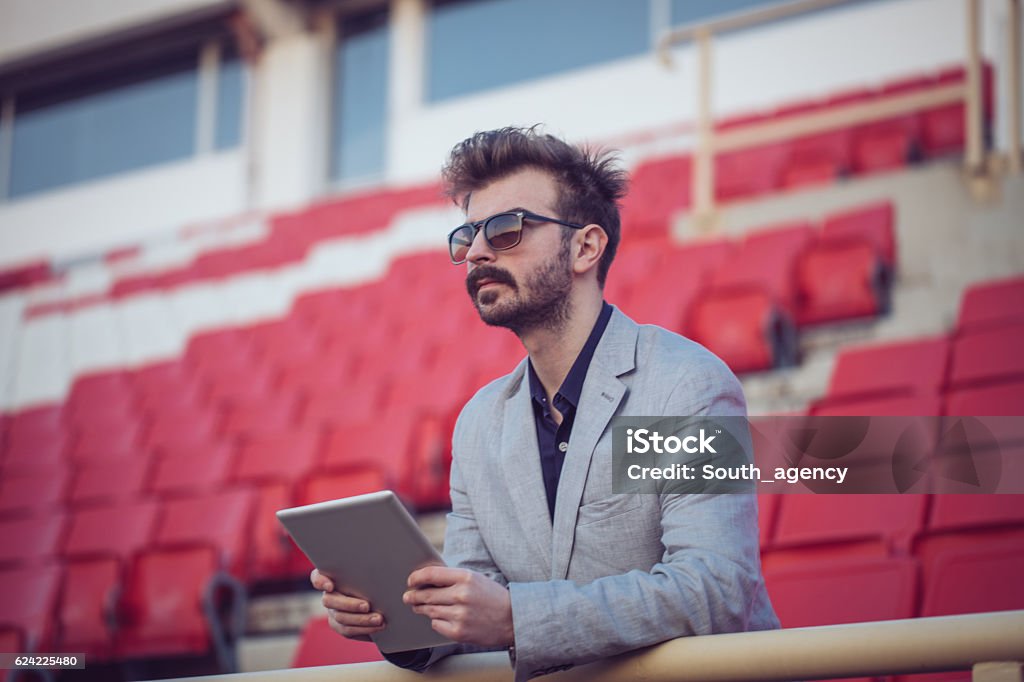 Football journalist viewed football team Soccer manager watches the players.Football coach observes training.Football coach writes on its tablet strategy.Football journalist viewed football team.Scout watching football team. Businessman Stock Photo