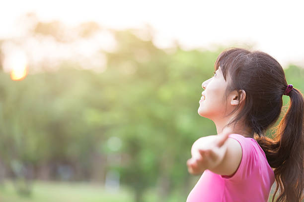 istock young woman raising her arms 624225502