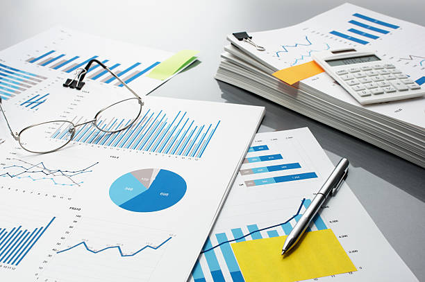 istock Preparing report. Blue graphs, glasses, calculator and pen. 624226912