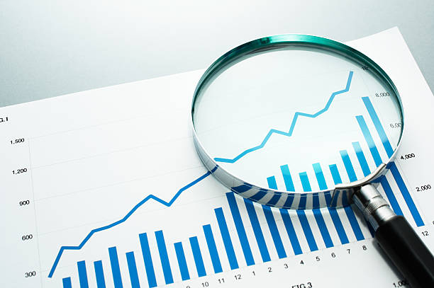istock Reviewing financial report. Looking at growth chart with magnify 624227038