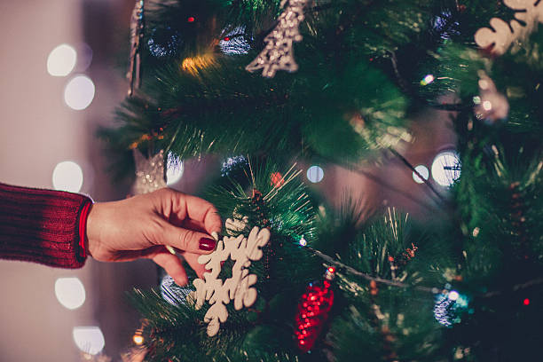 istock Young Woman Decorating Christmas Tree 624248992