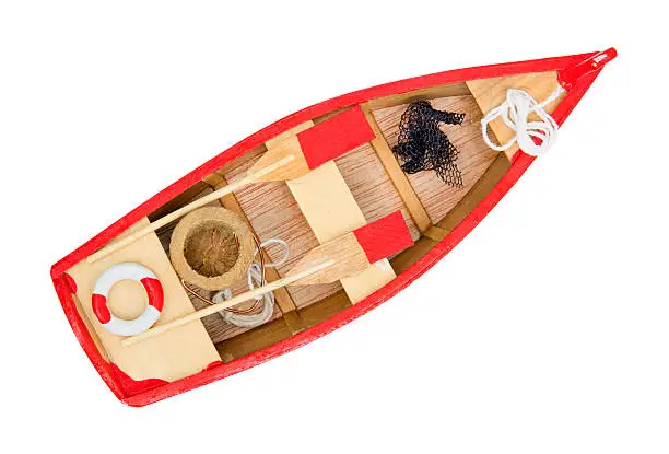 Isolated wooden boat with paddles