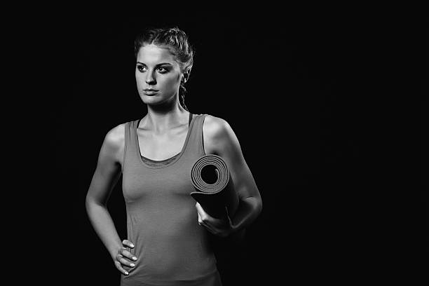 istock Woman holding exercise mat and thinking 624250714