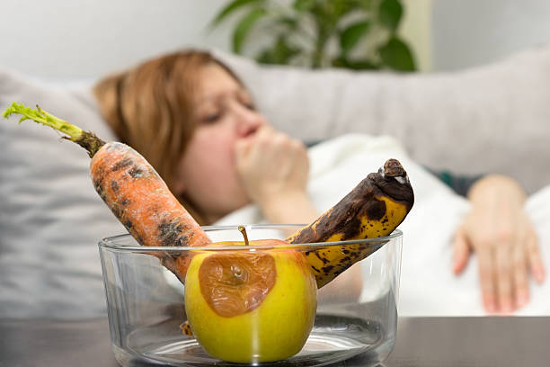 Bad food Woman has stomach ache due to rotten fruits and vegetables food poisoning photos stock pictures, royalty-free photos & images