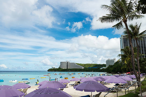 Guam, USA - November 11, 2016: Tumon Beach in Guam, USA. Tourists are resting on the beach or are enjoying water sports. Luxury hotels are located