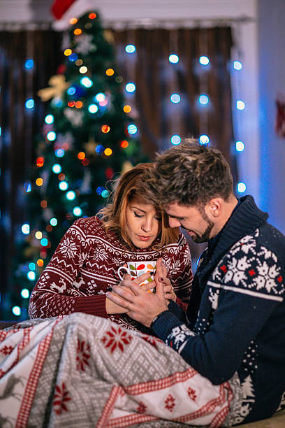 istock Happy couple at home with christmas tree 624267048