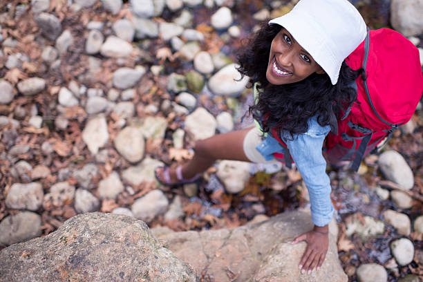 istock Close up backpacker woman walking on creek rocks. 624280812