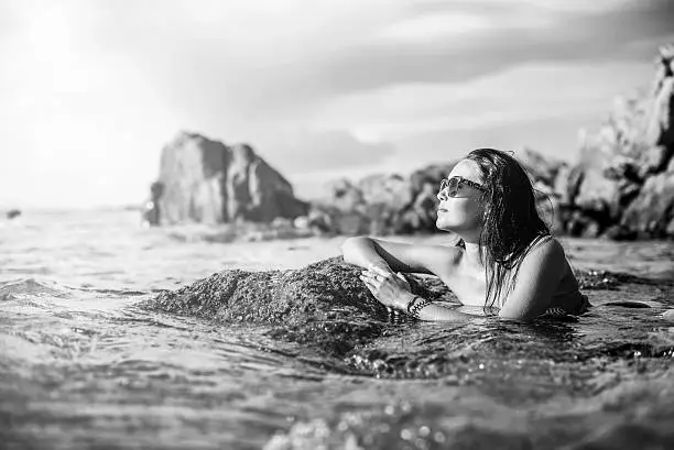 Photo of Young brunette girl relaxing in the water