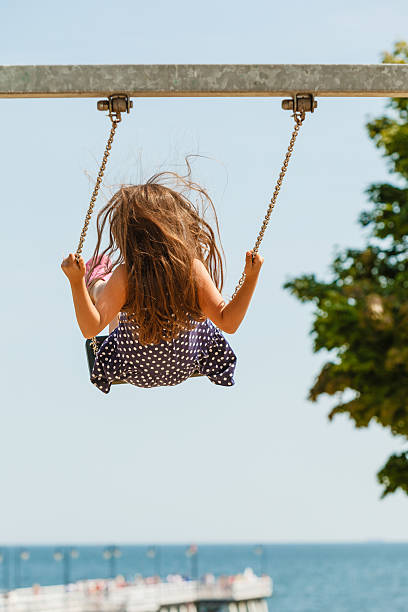 istock Girl swinging on swing-set. 624280892