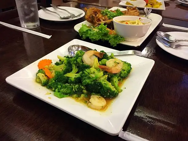 Stir-fired broccoli with shrimp on white dish