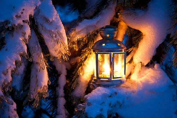 Christmas scene - an oil filled lantern burning bright with stock photo