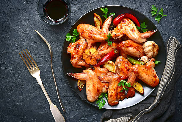 istock Grilled chicken wings on a black plate.Top view. 624282836