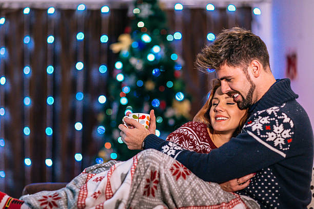 istock Happy couple at home with christmas tree 624283016