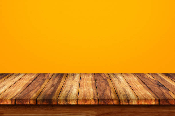 istock Empty top of wooden table on yellow background. 624284280