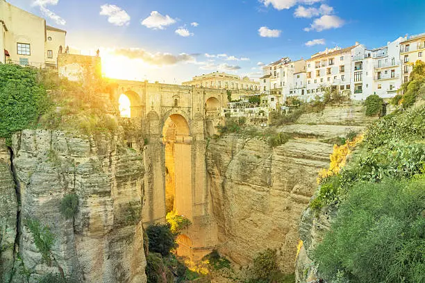 Puente Nuevo bridge colored with light of setting sun, Ronda, Andalusia, Spain