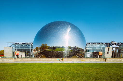 Paris, France - May 1, 2016: Parc de la Villette, La Geode and the Cite des Sciences et de l' Industrie Museum. The Geode an IMAX theatre inside of a 36 metres  diameter geodesic dome. 