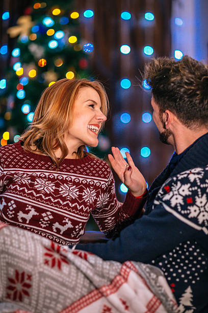 istock Happy couple at home with christmas tree 624285840