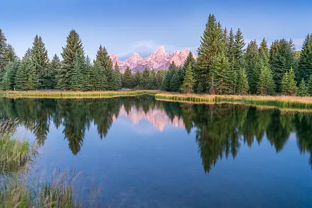 First sun rays hit the Peaks of Grand Teton National Park at Schwabacher's Landing. Nikon D810. Converted from RAW.