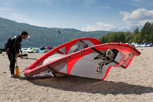 Lake Of Santa Croce, Italy – May 21, 2016: Kitesurfing action at the lake. Preparation, starting from the beach, sailing in the lake
