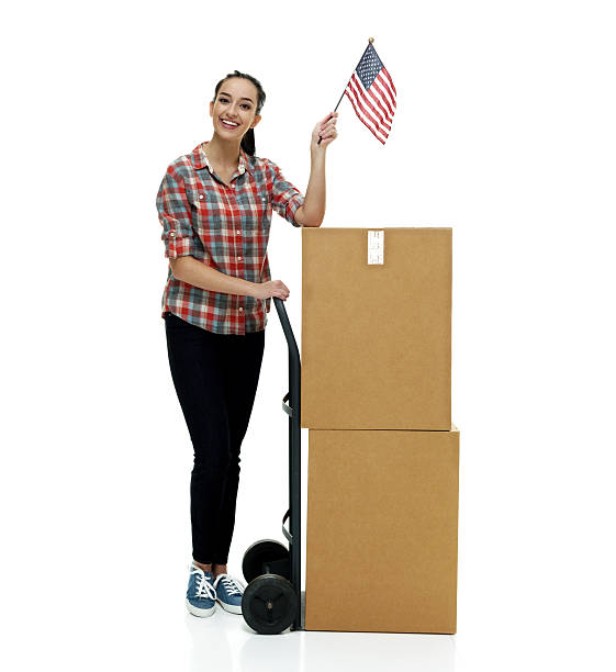 istock Smiling female holding American flag with box 624289576