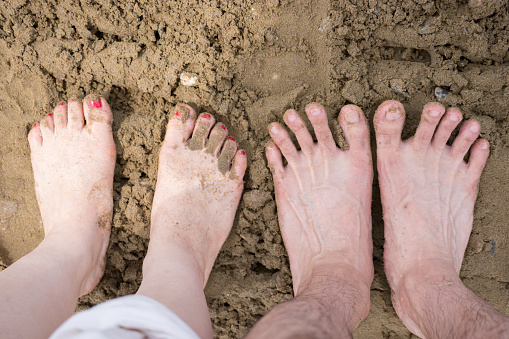 It is Couple's feet (sandy beach, beach, barefoot)