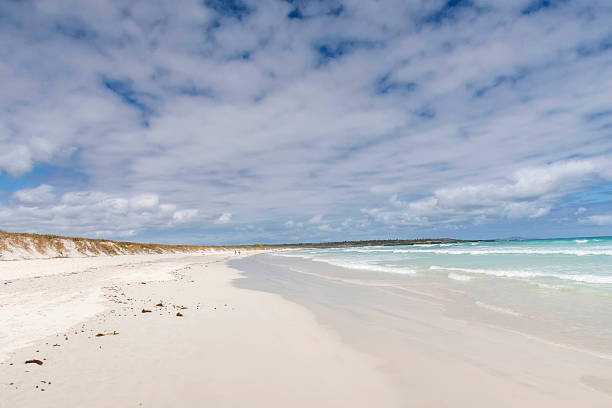 istock Water Washing Up On The White Sand with Galapagos view 624354720