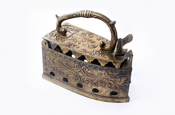 istock Vintage coal iron for used with budning embers isolated 624355508