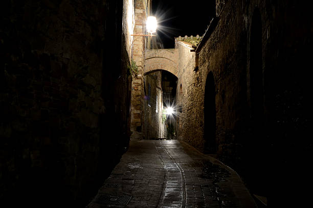 istock Narrow passage at night in San Gimignano, Italy 624355880