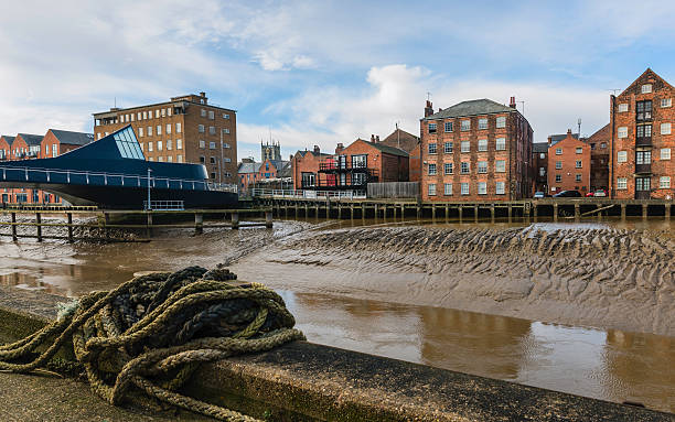 istock River Hull with bridge, flats, and church on the horizon. 624357062
