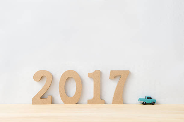 Happy New Year 2017 on a white background,On the right there is a car model