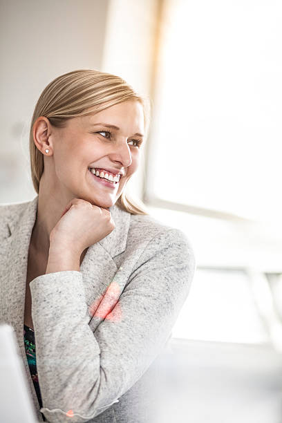istock Smiling young businesswoman looking away in creative office 624371530