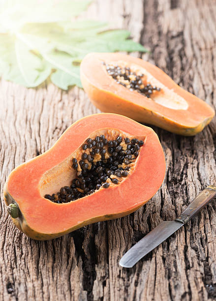 istock sliced papaya fresh fruit on wood background 624373150
