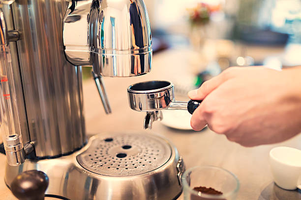 istock Lifestyle - Young man making espresso at home 624373708
