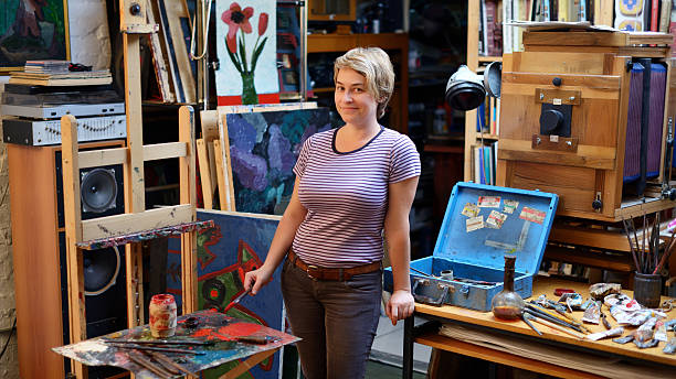 istock Woman artist paints in her workshop. 624375030