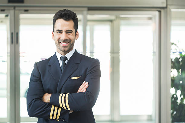 Aeroplane pilot looking at camera and smiling. Aeroplane pilot looking at camera and smiling. piloting stock pictures, royalty-free photos & images