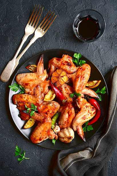 istock Grilled chicken wings on a black plate.Top view. 624391614