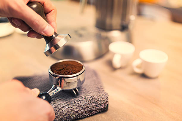 istock Lifestyle - Young man making espresso at home 624393104