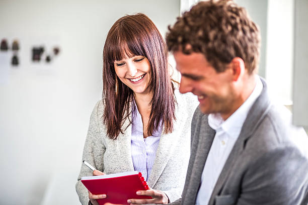 istock Smiling young business people discussing in office 624409120