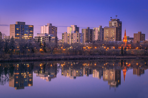 View of the Saskatoon skyline along the riverbank of the South Saskatchewan River.