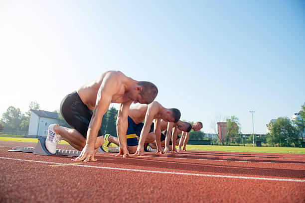 istock Male athletics runners on starting line without shirts. 624433354