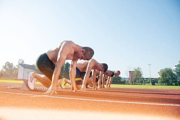 istock Male athletics runners on starting line without shirts. 624433626