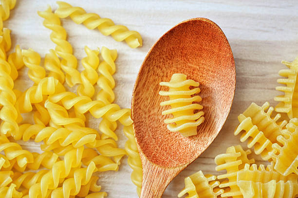 istock still life of wooden spoon on white table with pasta 624433740
