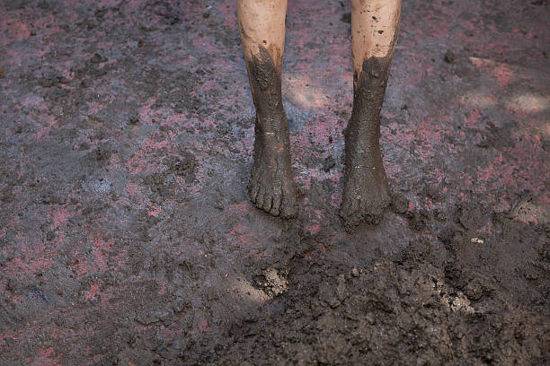 istock Kid dirty barefeet on muddy ground 624434134