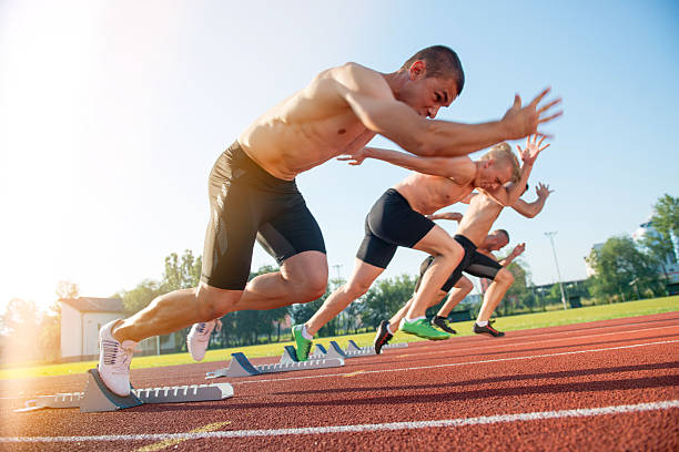 istock Male athletics runners on starting line without shirts. 624434254