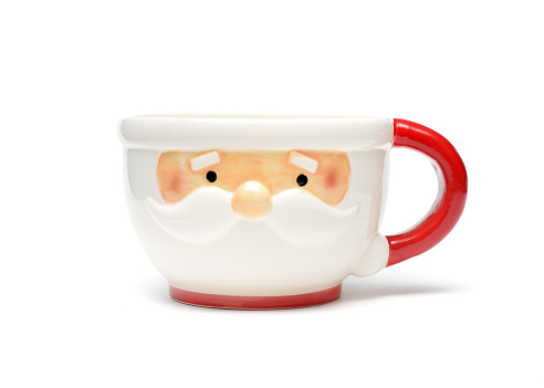 Closeup of a mass produced mug that looks like Santa Claus on a white background. 