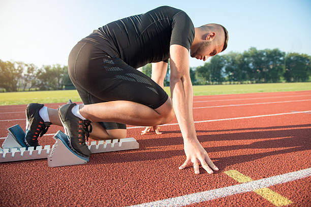 istock Male athlete on starting position at athletics running track. 624437208