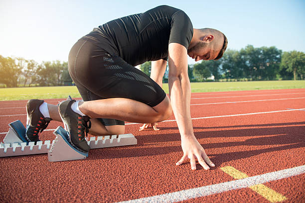 istock Male athlete on starting position at athletics running track. 624437880
