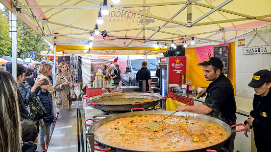 Bergamo, Italy - October 8, 2016: Sales of paella in a large international event of street food that takes place every year in Bergamo.Customers are waiting for the paella is ready.