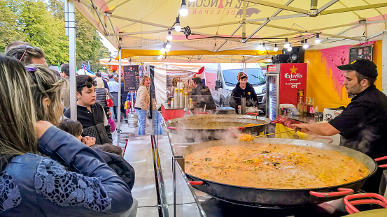 Bergamo, Italy - October 8, 2016: Sales of paella in a large international event of street food that takes place every year in Bergamo.Customers are waiting for the paella is ready.